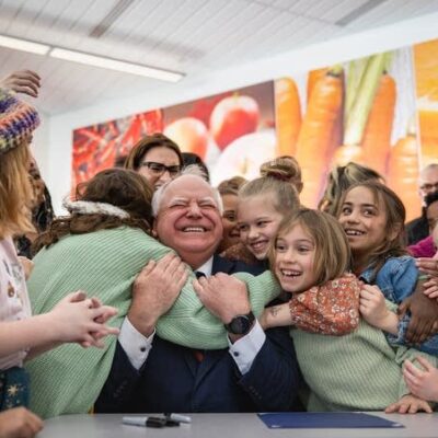 Tim Walz being mobbed by children after signing school lunch bill in Minnesota